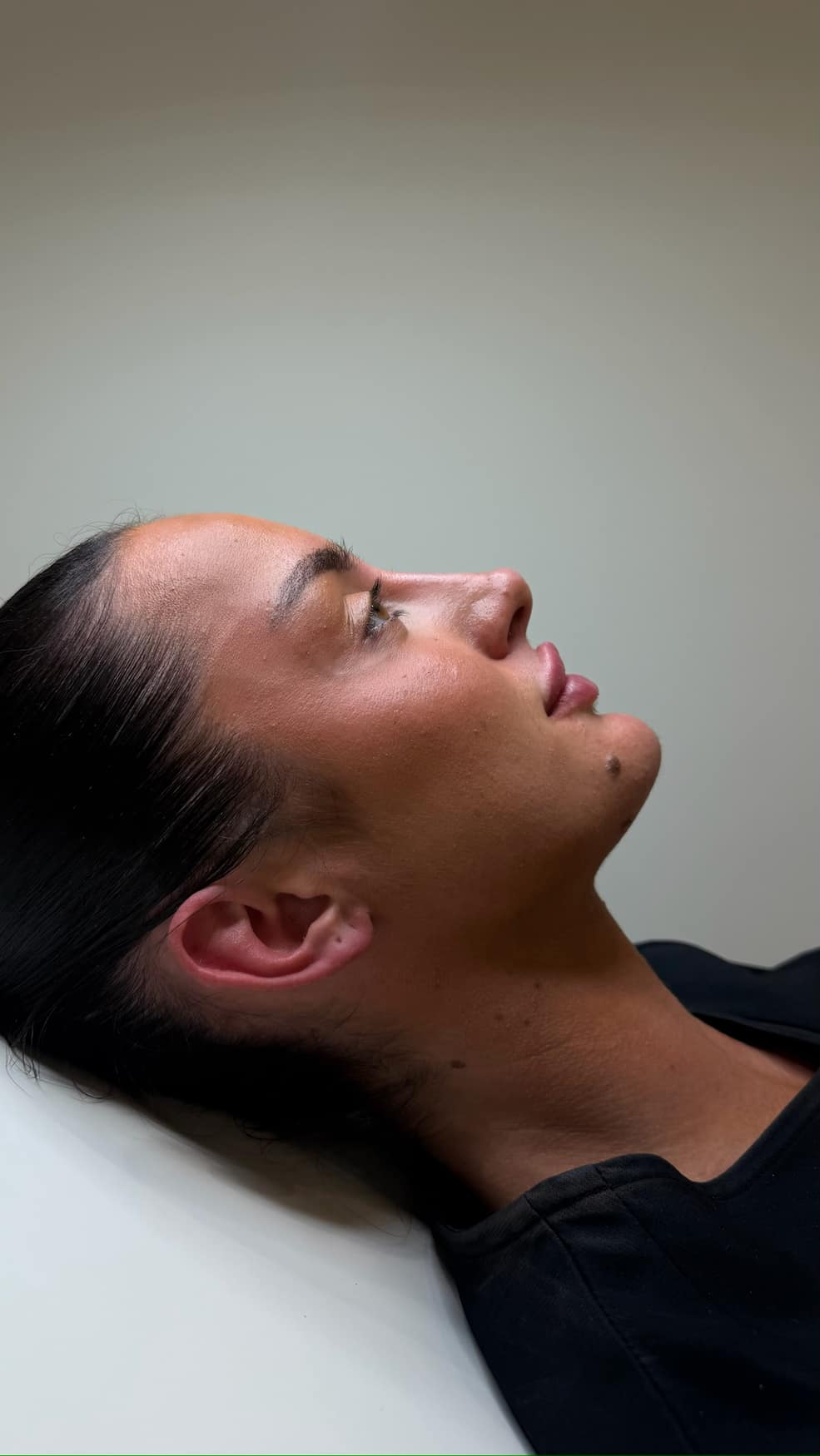 Side profile of a client resting at Face by Demi