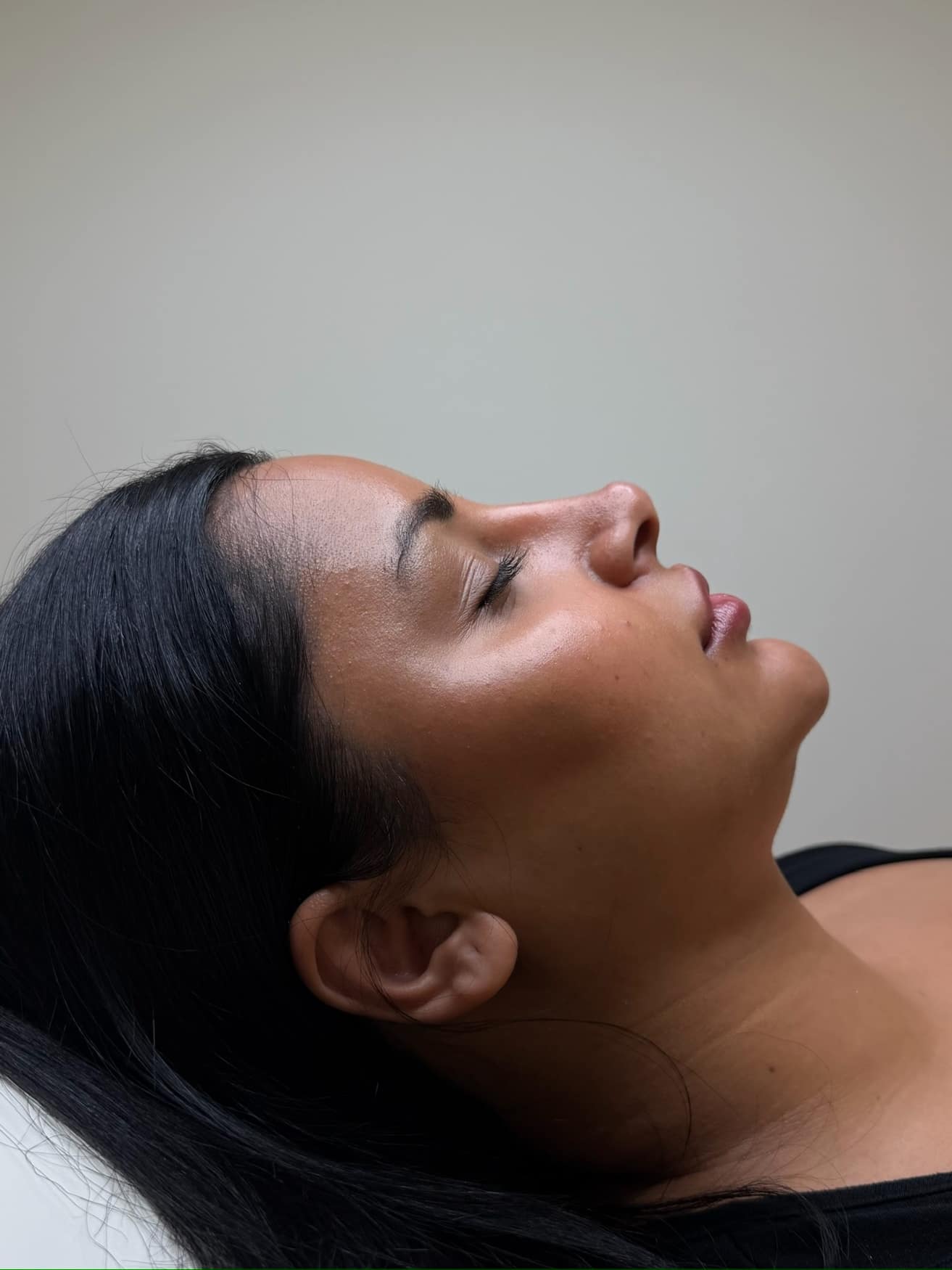 A client resting with a healthy skin glow
